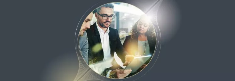 Group of professionals discussing something on a tablet.
