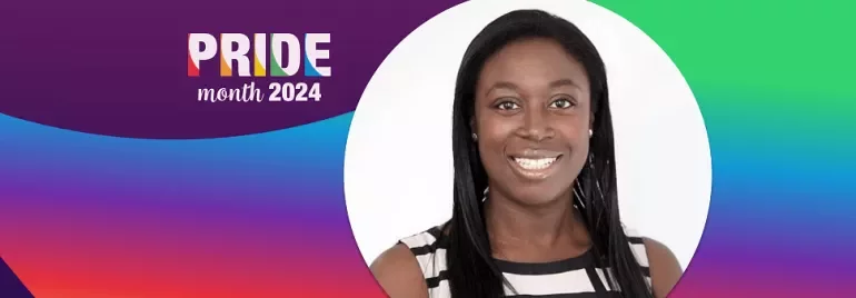 Person smiling in a black-and-white striped top with Pride Month 2024 design.