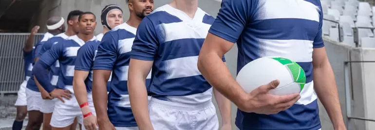 a group of rugby players entering the field