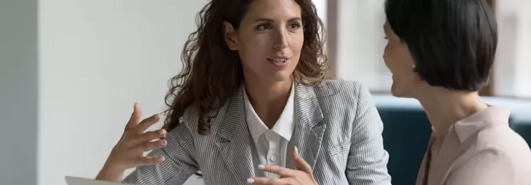 two women talking in the office