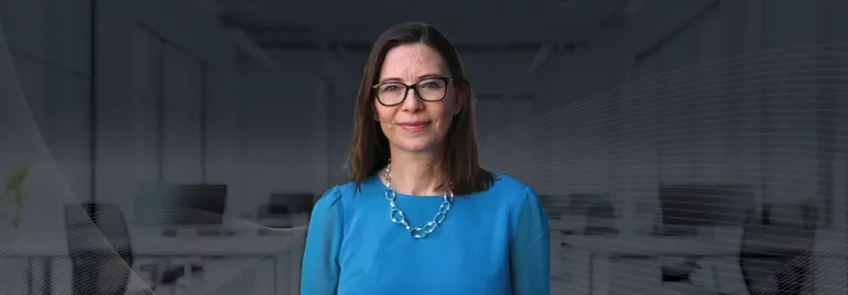Consultant Nina Buttle, smiling against an office background
