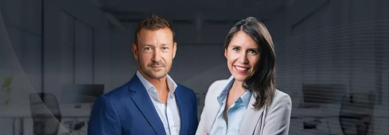 Lorena Gutiérrez Filomeno and Olly Riches in front of an office background