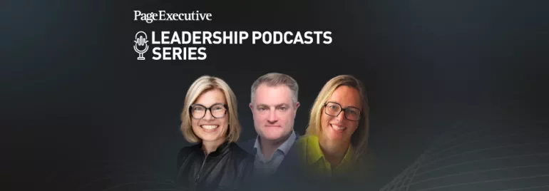Group of three people in professional attire standing against a dark background with abstract golden lines.