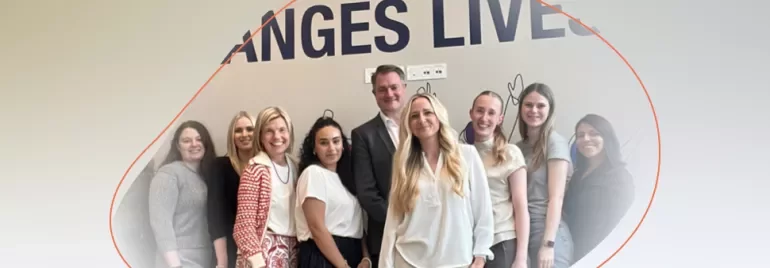 a group of university students standing and smiling