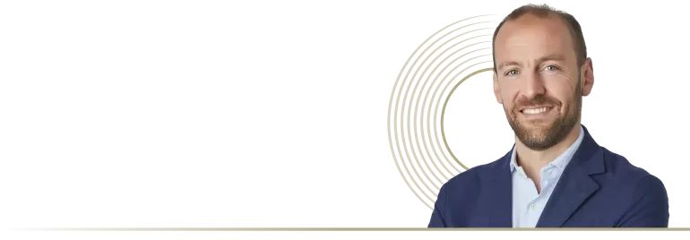 a man smiling with a circle shape in the background