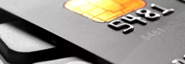 Close-up of a black credit card with an EMV chip.