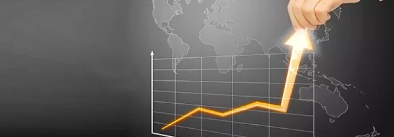 Hand lifting an arrow on a graph with a world map background.