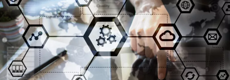 Person interacting with digital technology and cloud icons on a transparent screen.