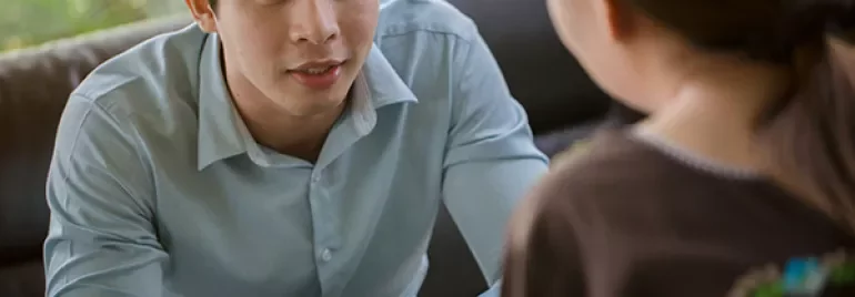 Two people having a focused conversation indoors.