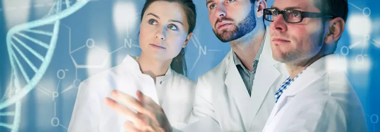 Three people in lab coats study digital DNA graphics.