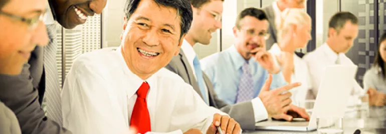 People in business attire having a meeting in a modern office.