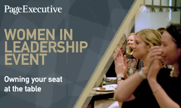 Conference attendees applauding, with 'Women in Leadership Event' on screen.