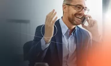 a man smiling talking on the phone
