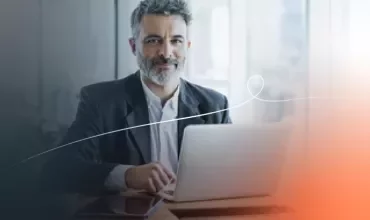 a man smiling with a computer