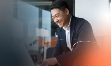 a man smiling with a computer