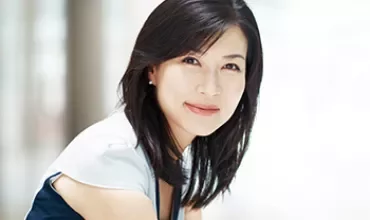 Person smiling softly, wearing casual clothing.
