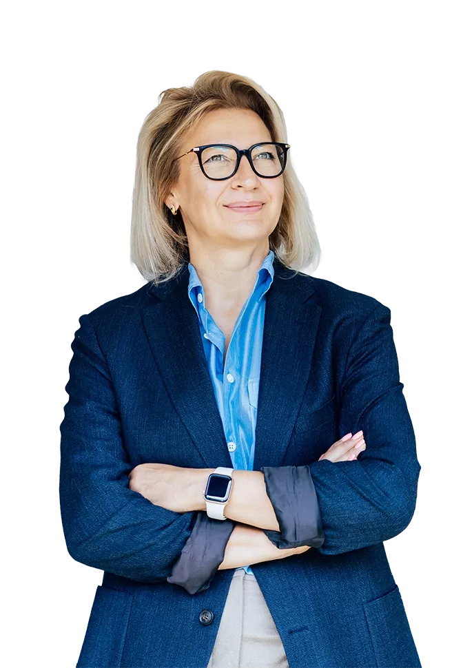 Professional portrait of a person wearing glasses and a blue blazer with arms crossed.