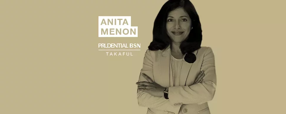 Person in a suit with arms crossed near the words Anita Menon Prudential BSN Takaful.