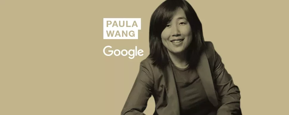 Person smiling in front of a beige background with Google logo.