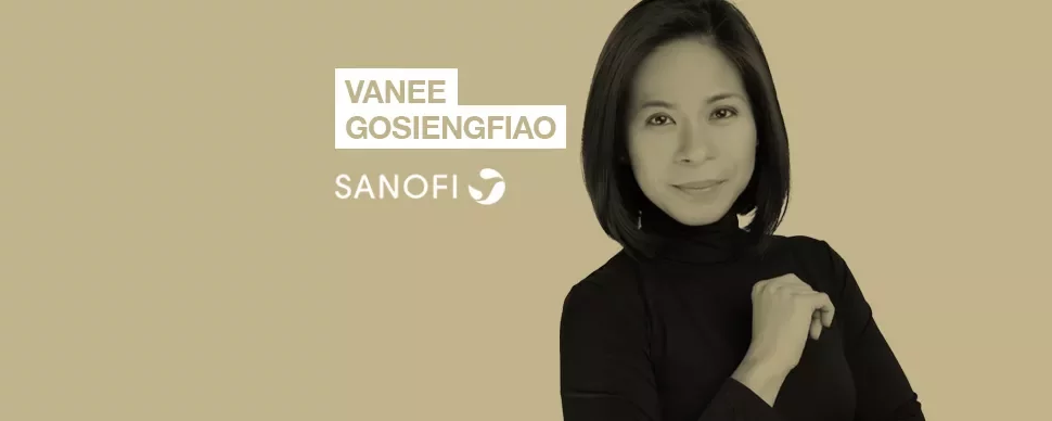 Person in black shirt with text 'Vanee Gosiengfiao' and 'Sanofi' on beige background.