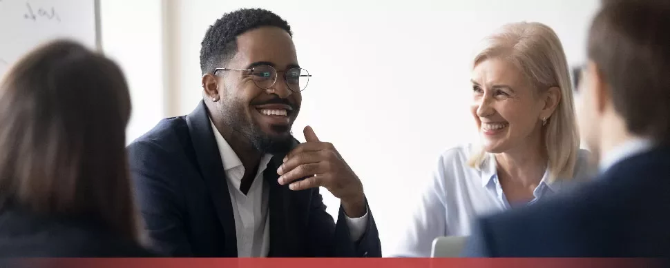 Colleagues smiling in a meeting.