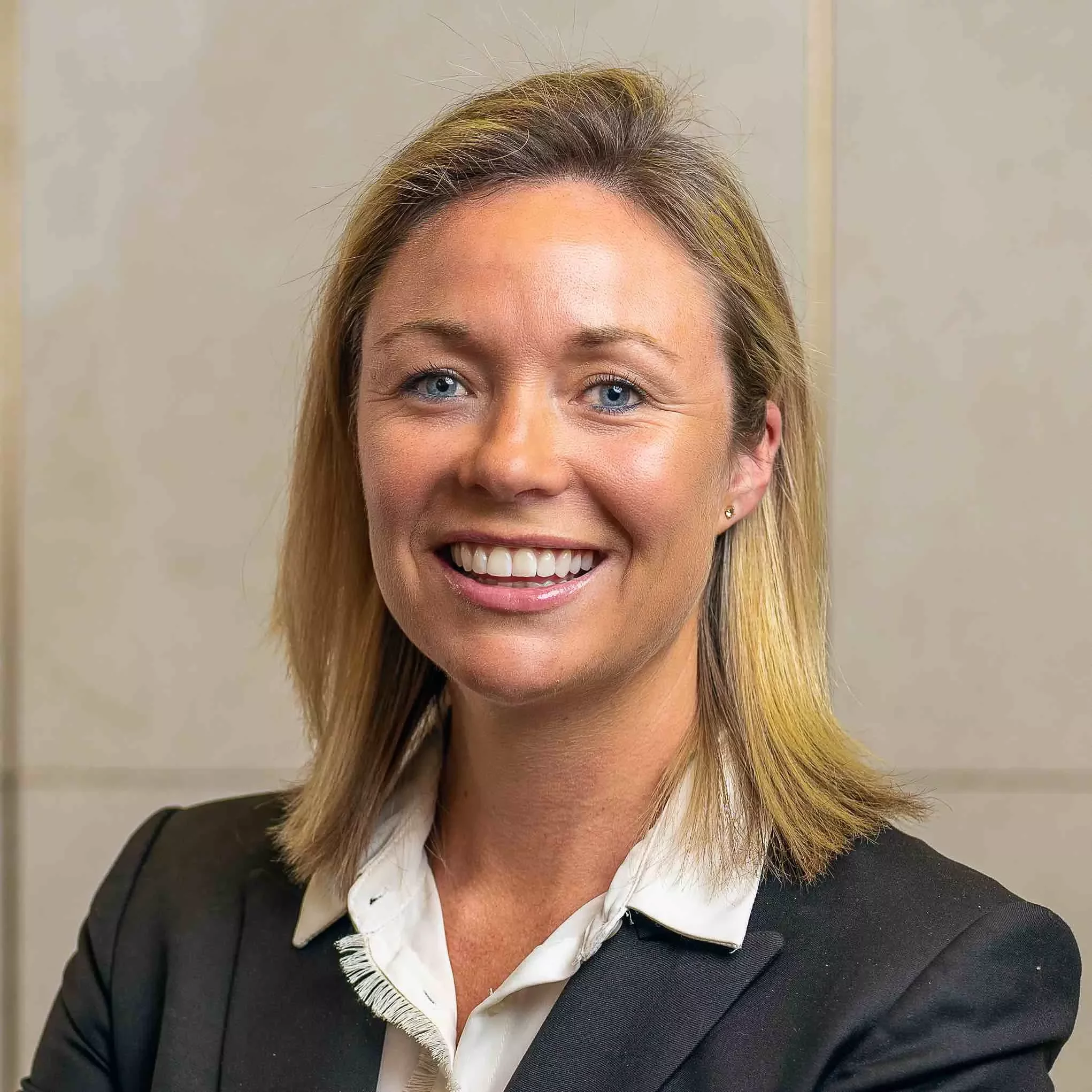 Person smiling in a professional setting.