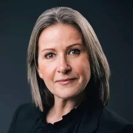 Portrait of a person with short gray hair and a black jacket.