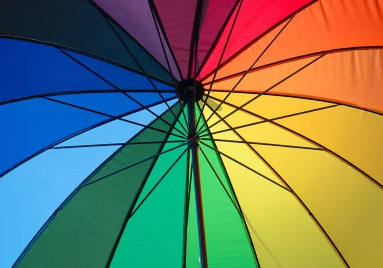 A colorful umbrella with vibrant segments in a spiral pattern.