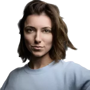 Portrait of a person with short brown hair in a blue shirt, looking directly at the camera.