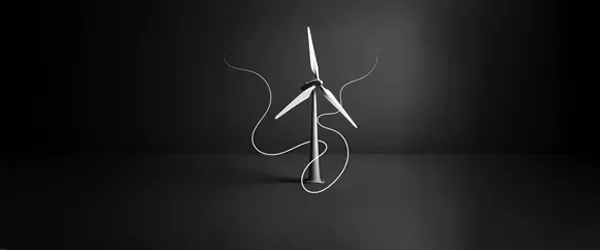 Wind turbine with three blades standing against a dark background.