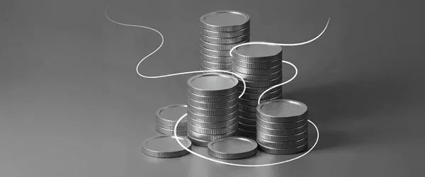 Stacks of silver coins arranged in different heights with a thin metallic line swirling around them