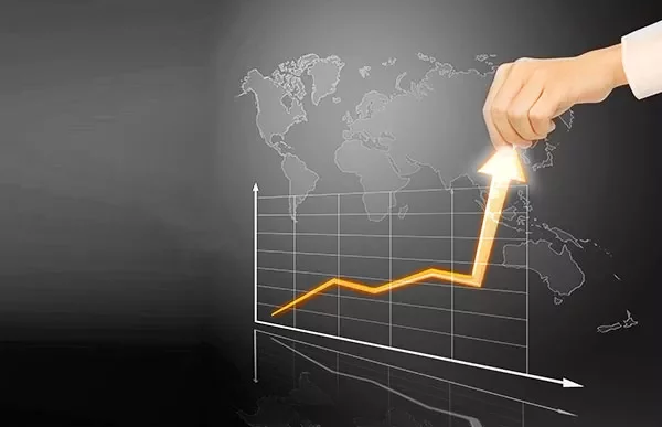 Hand lifting an arrow on a graph with a world map background.