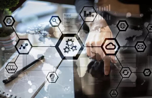 Person interacting with digital technology and cloud icons on a transparent screen.