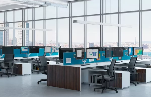 Modern office with large windows and rows of desks with computers.