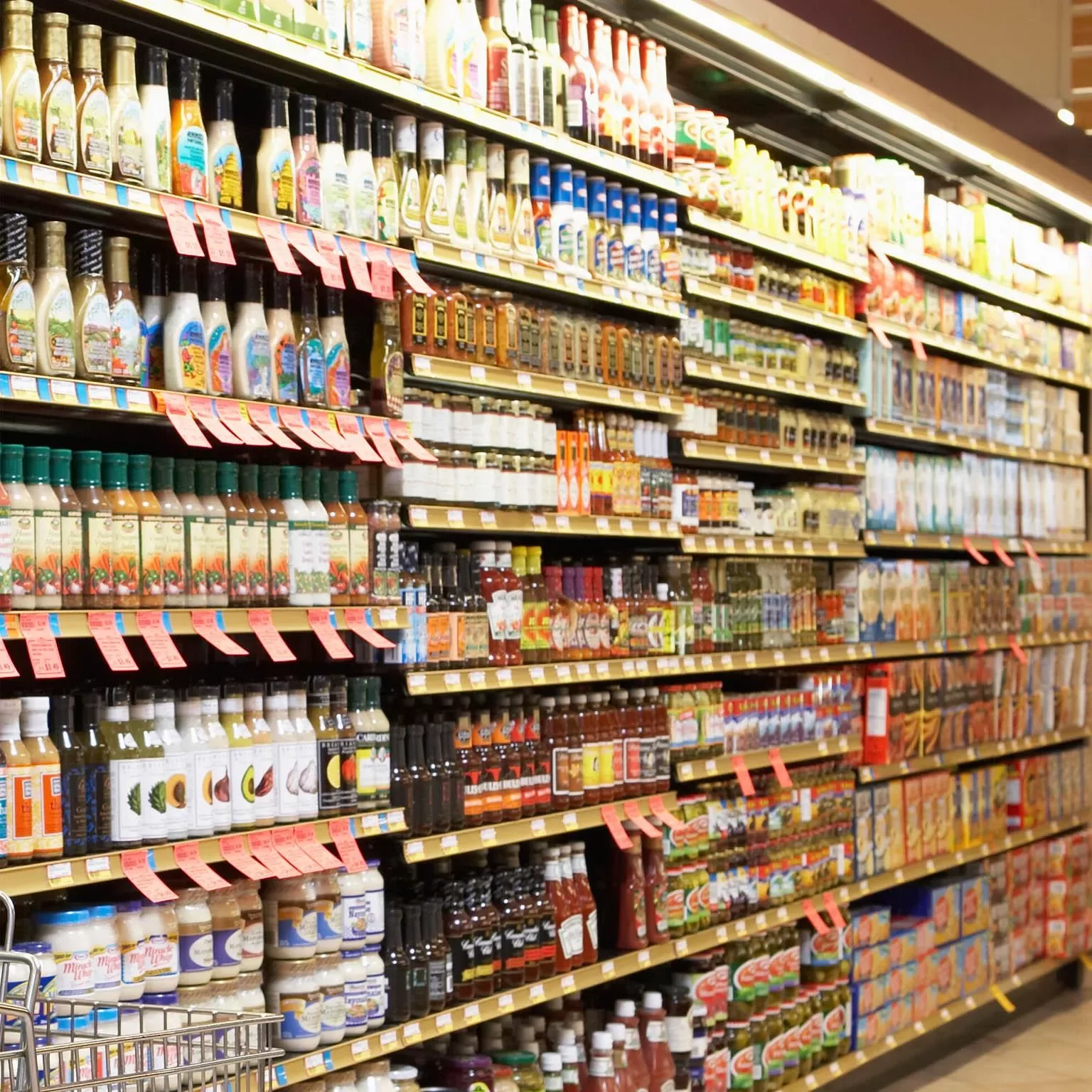 A grocery store aisle filled with salad dressings and condiments.